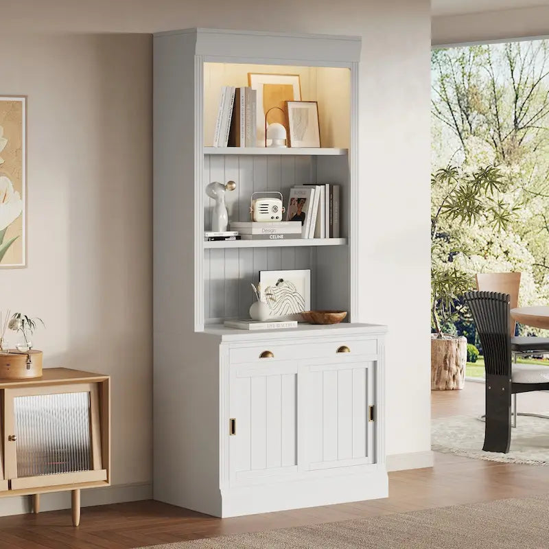 Tall Bookcase with LED Top Lighting 3 Open Shelves Center Drawer 2 Sliding Doors Beadboard Panels and Gold Semicircle Pulls