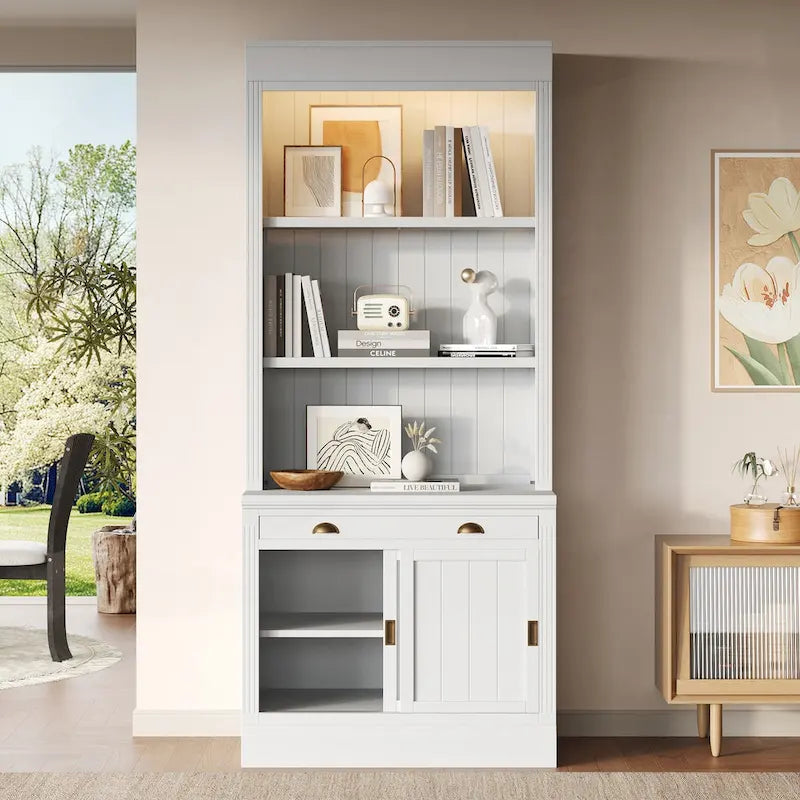 Tall Bookcase with LED Top Lighting 3 Open Shelves Center Drawer 2 Sliding Doors Beadboard Panels and Gold Semicircle Pulls